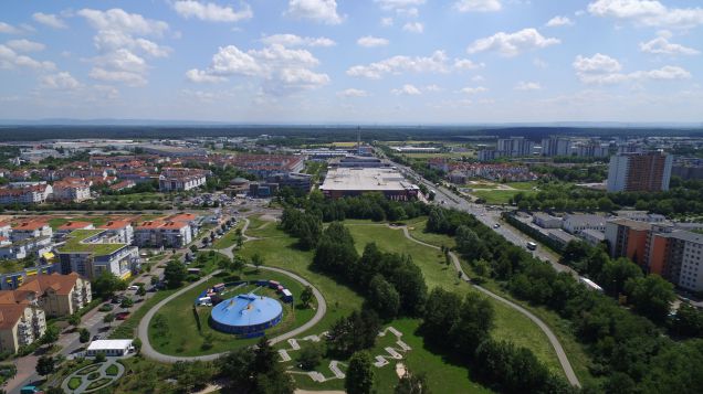 Zentral im Bild ist aus Vogelperspektive ein großer Park. Darum sind Stadtgebäude sichtbar.